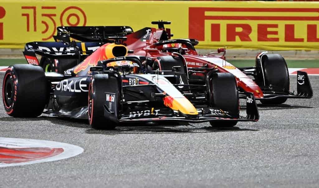 Max Verstappen and Charles Leclerc racing around the opening bend at the 2022 Bahrain Grand Prix.