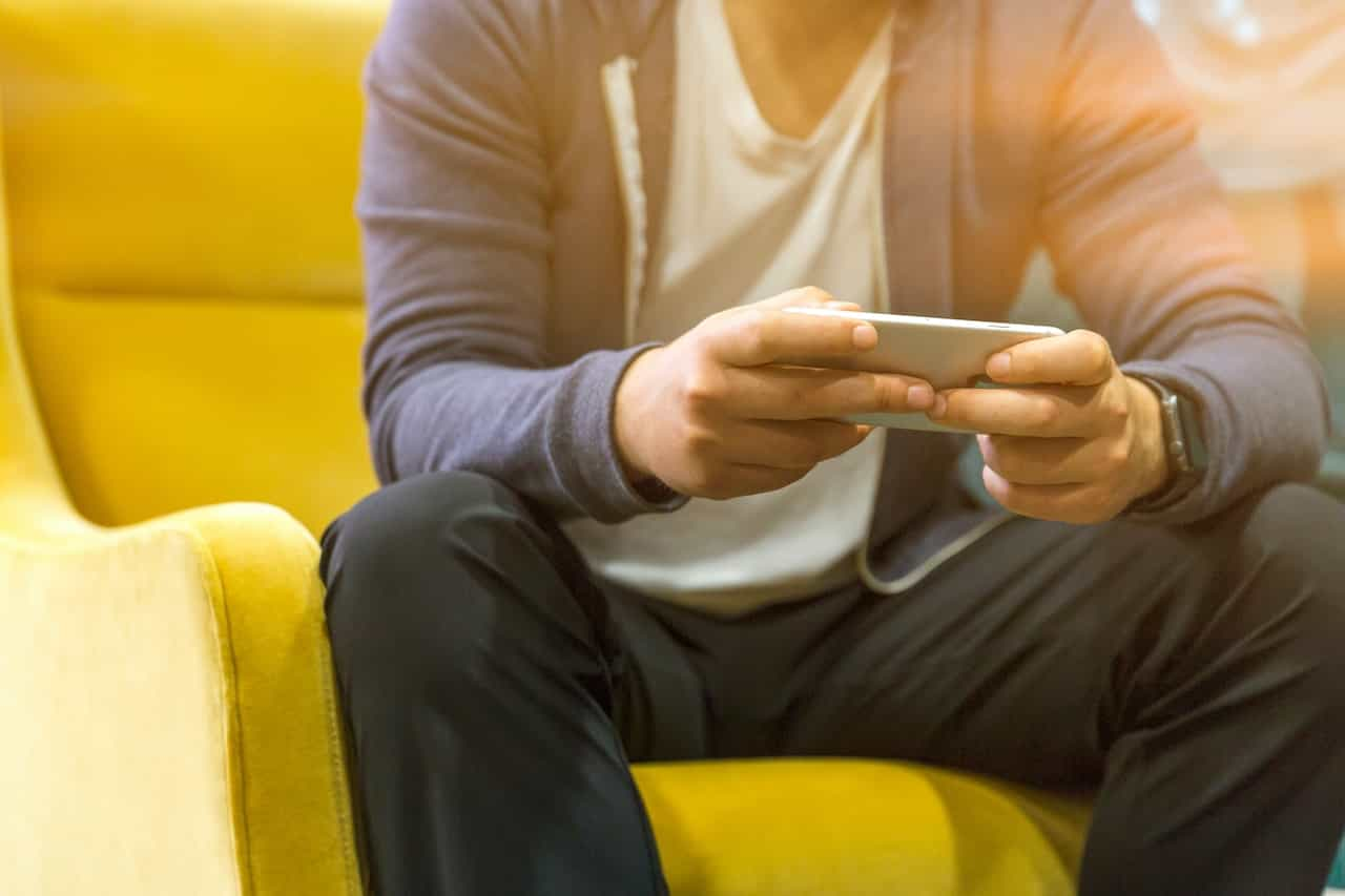 A man looking at a mobile phone.