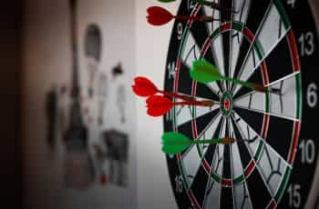 A dartboard with darts.