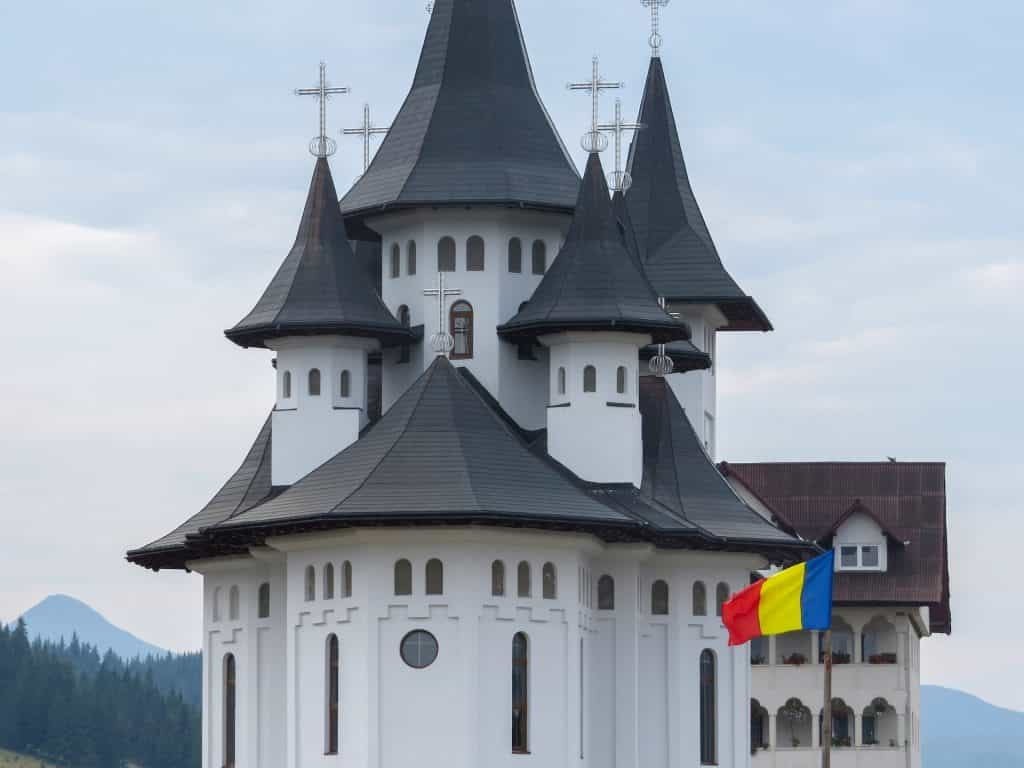 A flag against a cathedral.